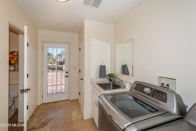 laundry area with washer / clothes dryer, cabinet space, a sink, and visible vents