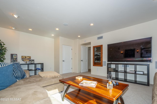 living area featuring carpet floors, visible vents, and recessed lighting