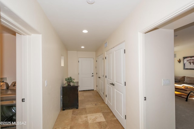 hall featuring washer / clothes dryer and recessed lighting