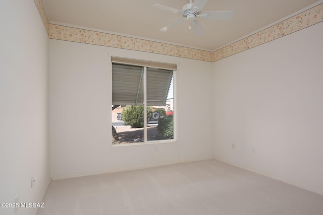 carpeted spare room featuring a ceiling fan