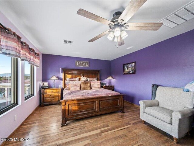 bedroom featuring hardwood / wood-style flooring and ceiling fan