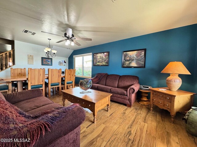 living room featuring ceiling fan and light hardwood / wood-style flooring