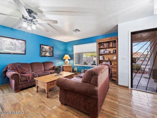 dining area featuring hardwood / wood-style flooring and ceiling fan with notable chandelier