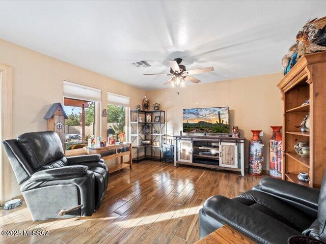 living room featuring hardwood / wood-style floors and ceiling fan