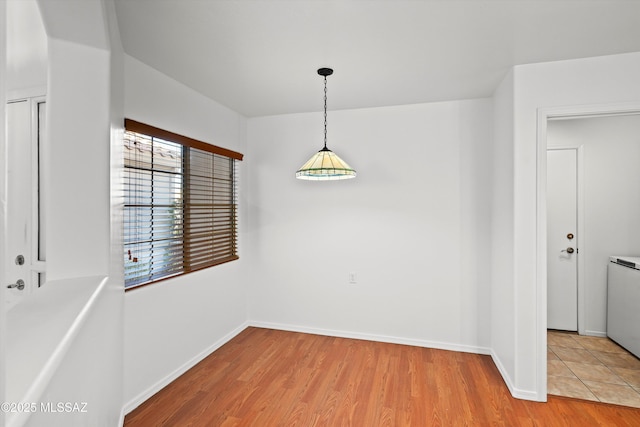 unfurnished dining area with light hardwood / wood-style flooring