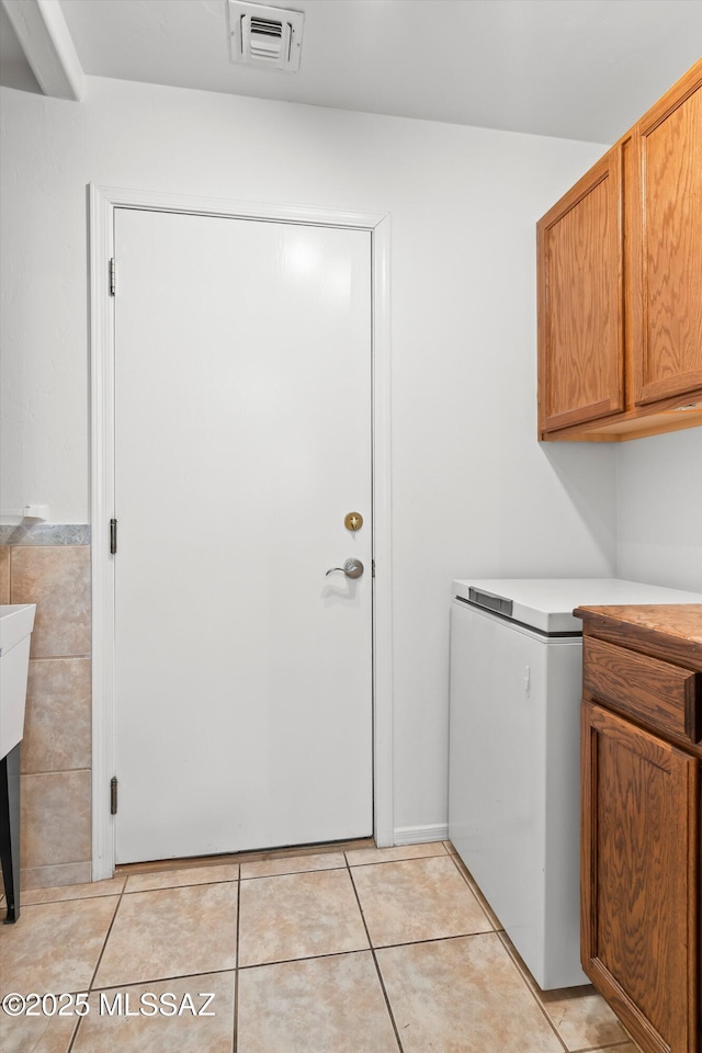 washroom featuring tile walls and light tile patterned floors