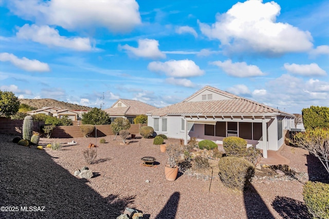 rear view of house with a fire pit