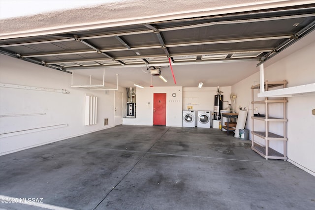 garage with a garage door opener, water heater, and washing machine and clothes dryer