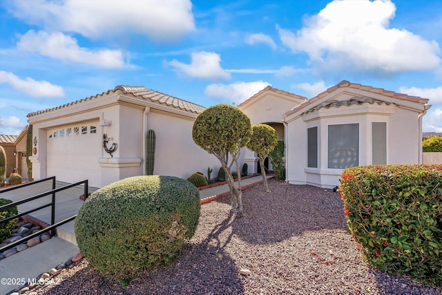 mediterranean / spanish-style home with a garage