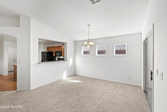 interior space with a chandelier, light carpet, and lofted ceiling