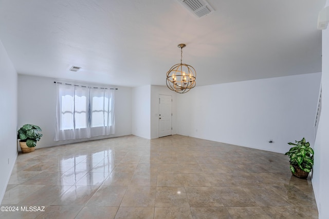 empty room featuring a chandelier