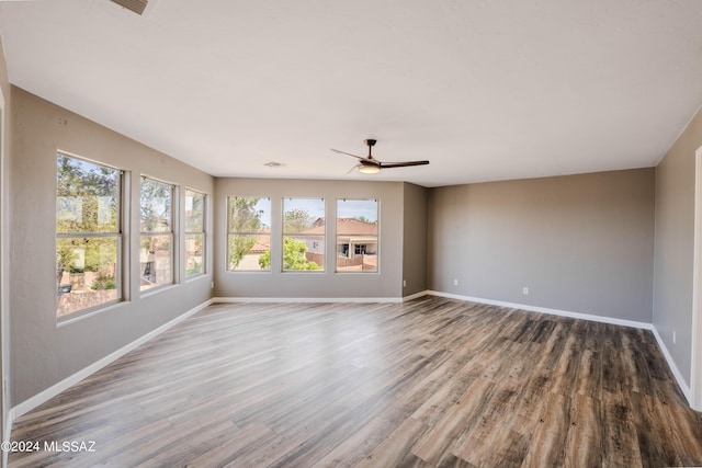 unfurnished living room featuring ceiling fan and wood-type flooring