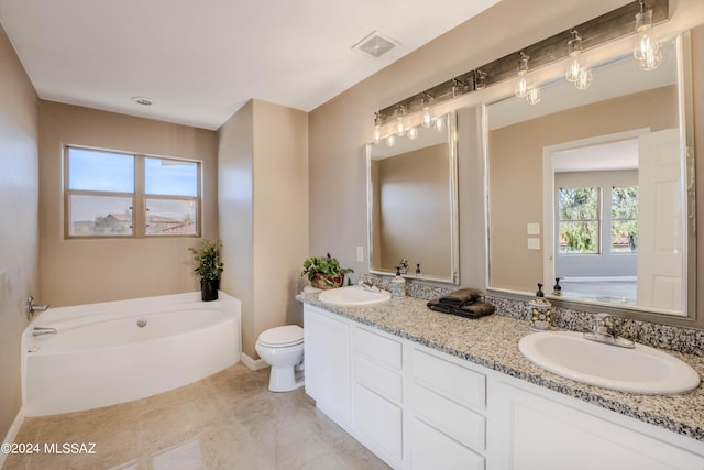 bathroom with a tub, toilet, tile patterned floors, and vanity