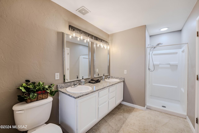 bathroom featuring toilet, walk in shower, and vanity