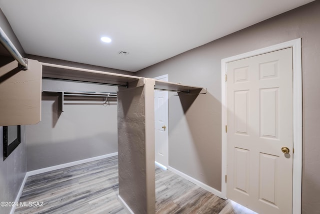 spacious closet featuring hardwood / wood-style flooring