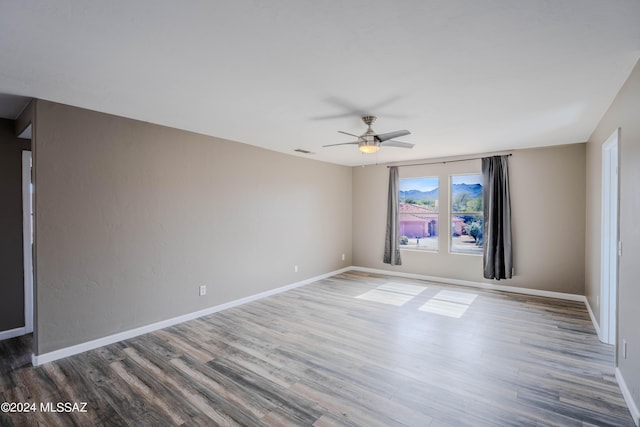 empty room featuring ceiling fan and wood-type flooring