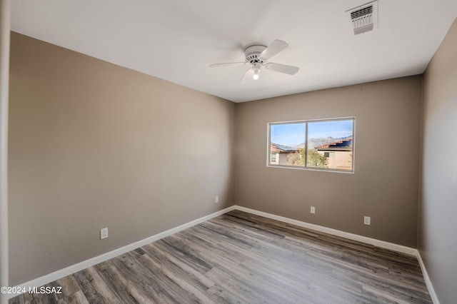 empty room with hardwood / wood-style flooring and ceiling fan