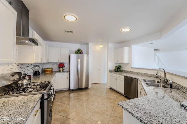 kitchen featuring white cabinets, light tile patterned floors, light stone countertops, range hood, and stainless steel appliances