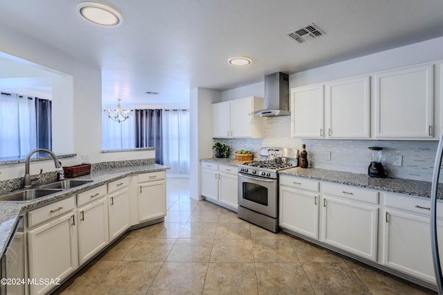 kitchen featuring sink, white cabinets, appliances with stainless steel finishes, and wall chimney exhaust hood