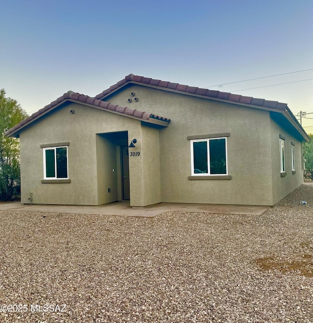 rear view of property featuring a patio area