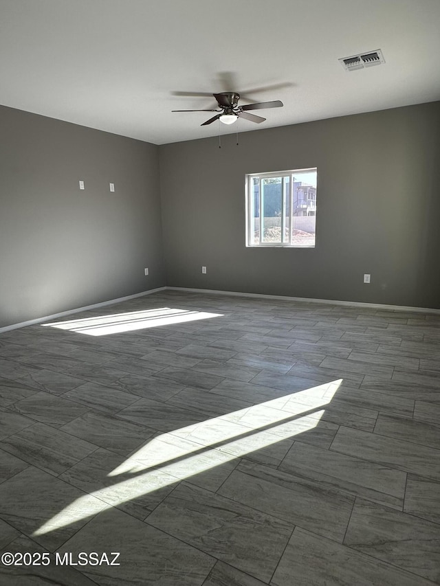 spare room with ceiling fan