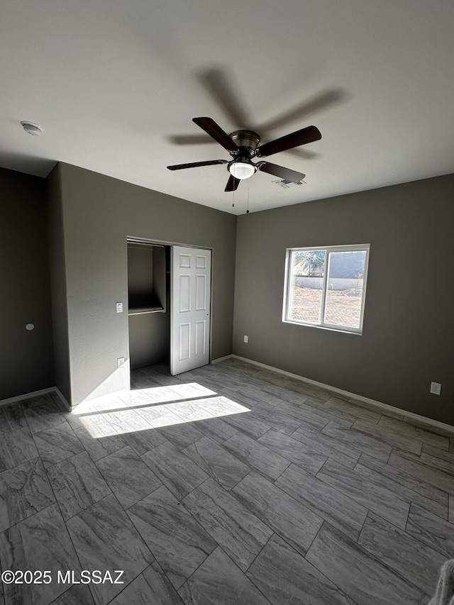 unfurnished bedroom with a closet and ceiling fan