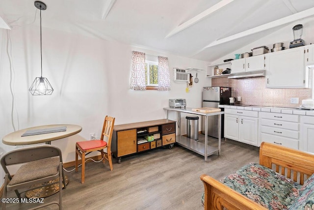 kitchen featuring white cabinetry, backsplash, and pendant lighting