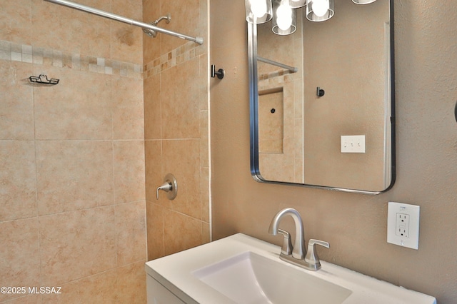 bathroom featuring vanity and a tile shower