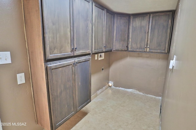 clothes washing area with cabinets, washer hookup, and hookup for an electric dryer