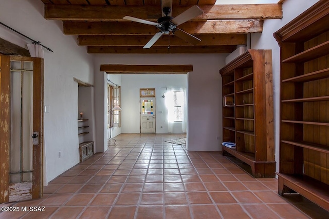 interior space with ceiling fan, beam ceiling, and tile patterned flooring