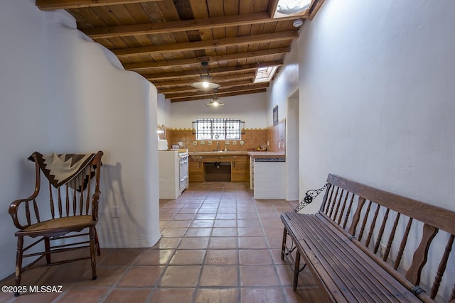 corridor featuring wood ceiling, sink, high vaulted ceiling, light tile patterned floors, and beam ceiling