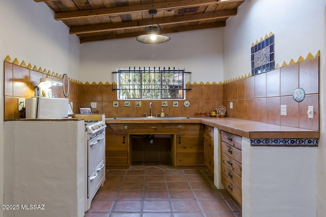 kitchen with tile patterned flooring, backsplash, a high ceiling, wooden ceiling, and beamed ceiling