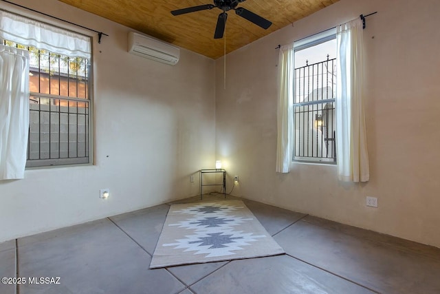 spare room with wood ceiling, ceiling fan, and a wall unit AC