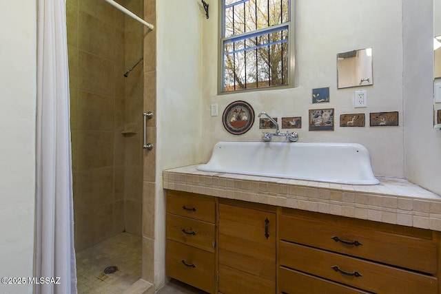 bathroom featuring vanity and a shower with shower curtain