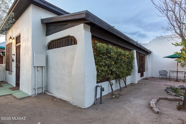 view of property exterior with a patio