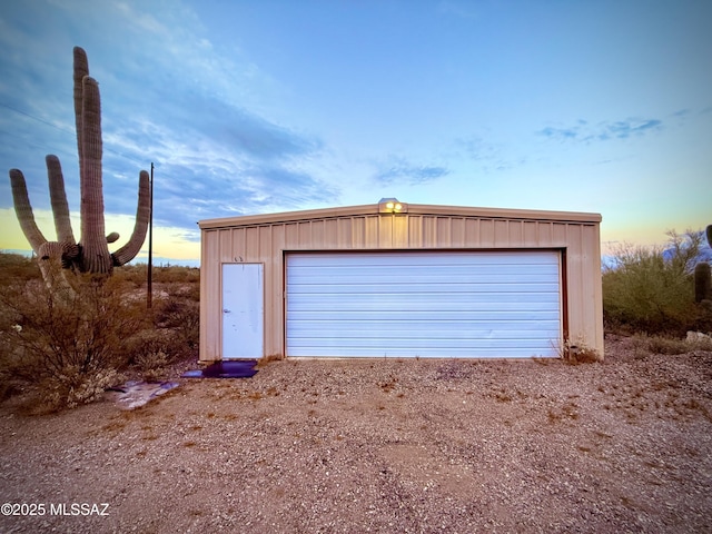 view of garage at dusk