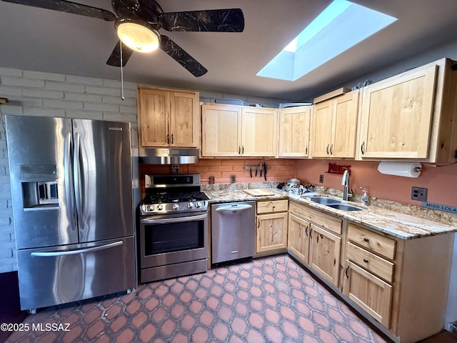 kitchen with sink, a skylight, light brown cabinets, ceiling fan, and stainless steel appliances