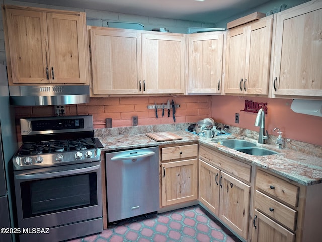 kitchen featuring light stone counters, appliances with stainless steel finishes, sink, and light brown cabinets