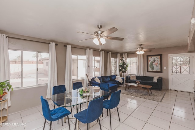 tiled dining space with ceiling fan