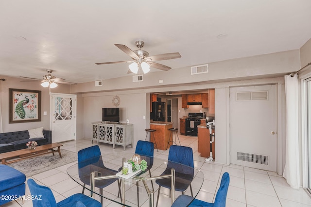 tiled living room featuring ceiling fan