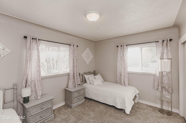 bedroom with multiple windows and light colored carpet