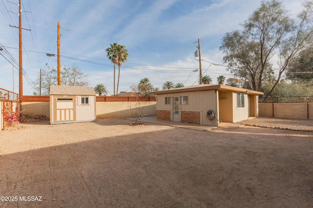 rear view of property featuring a shed