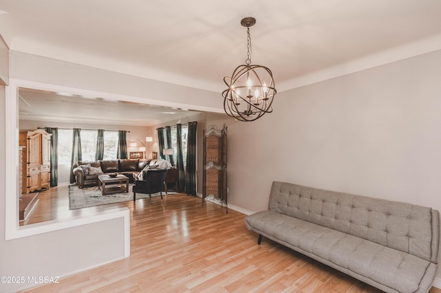 living room with a chandelier and light wood-type flooring