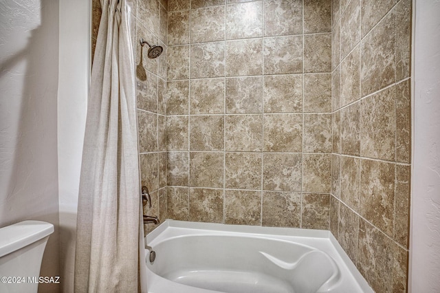 bathroom with shower / bath combo and toilet