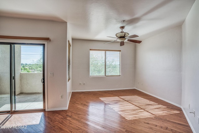 spare room featuring hardwood / wood-style flooring, plenty of natural light, and ceiling fan