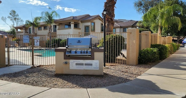 view of swimming pool featuring a grill