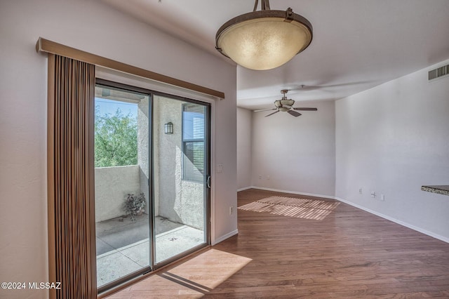 interior space featuring wood-type flooring and ceiling fan