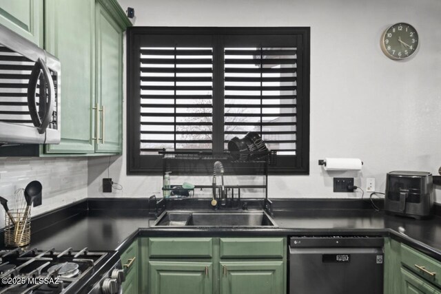 kitchen with sink, stainless steel appliances, and green cabinets