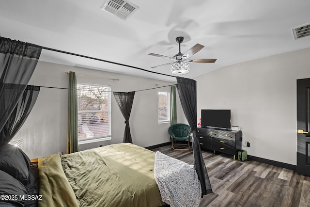 bedroom with baseboards, visible vents, a ceiling fan, and wood finished floors