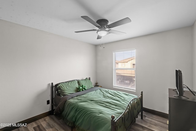 bedroom featuring dark hardwood / wood-style flooring and ceiling fan